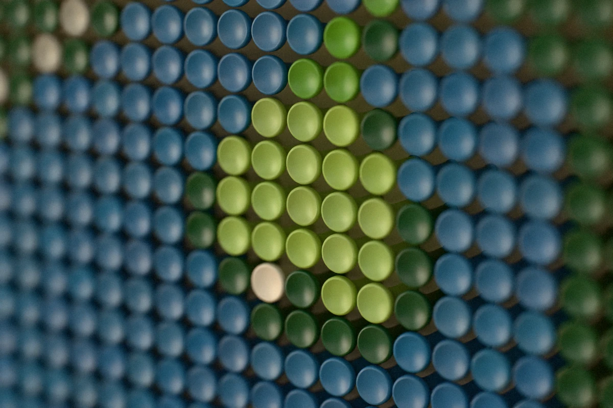 Close-up of the colored tees: blue water, the light-green putting surface and a single white tee for the bunker.
