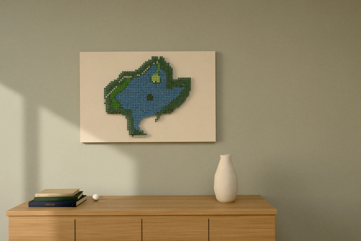 A golf-tee picture of a par 3 with a green surrounded by water, hung wide on a sage wall above a wooden sideboard with books and a vase.