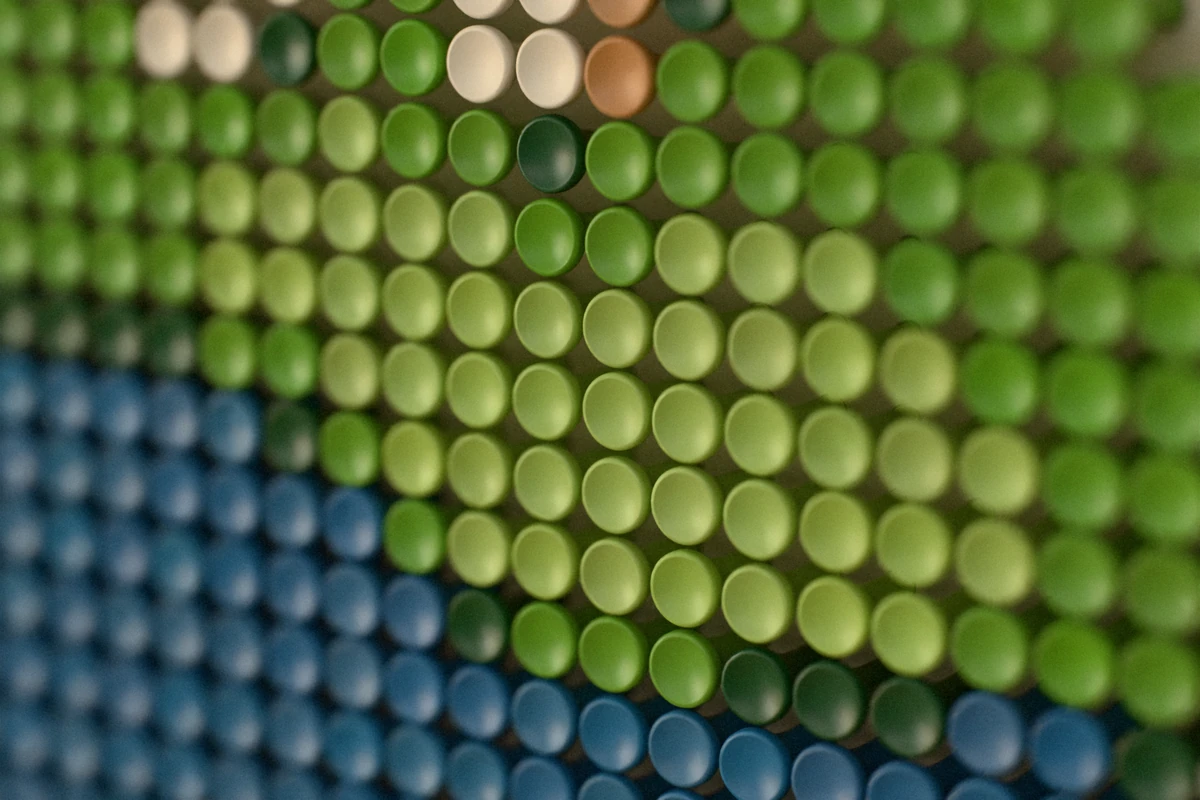 Close-up of the colored tees where the water meets the light-green putting surface.