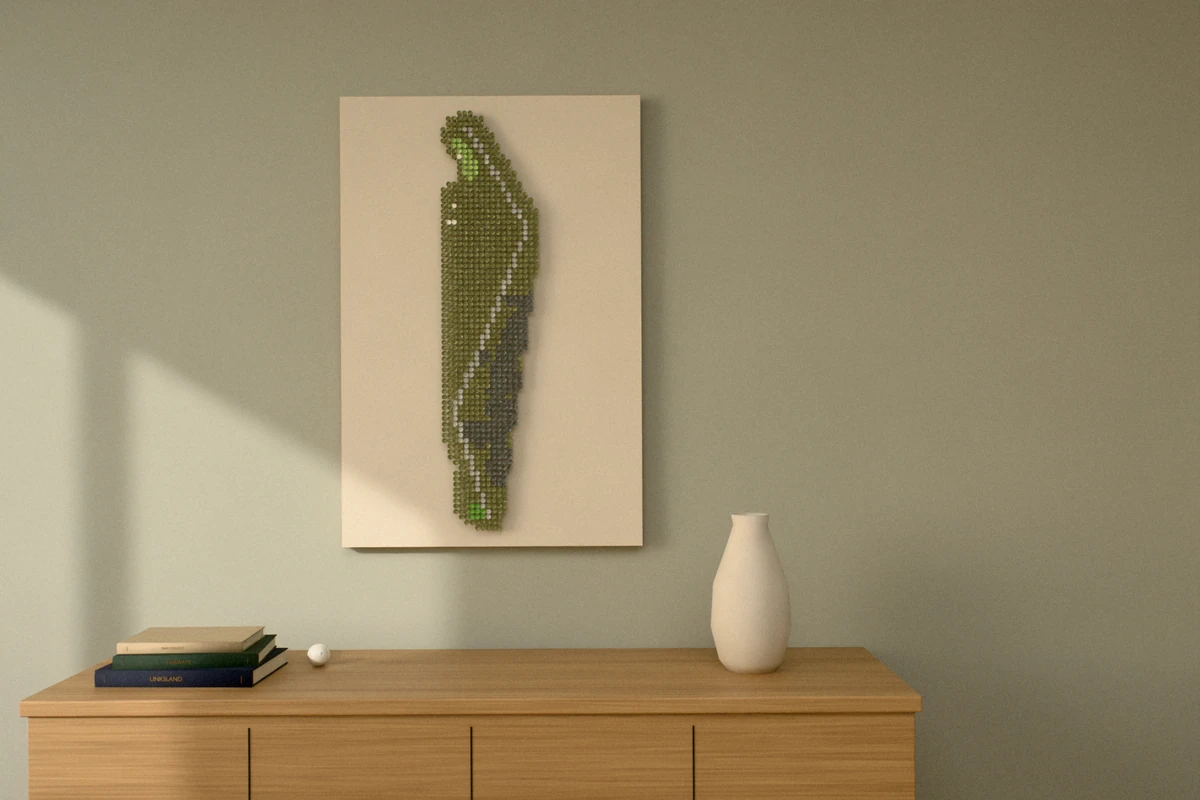 A golf-tee picture of a long par 4, hung tall on a sage wall above a wooden sideboard with books and a vase.